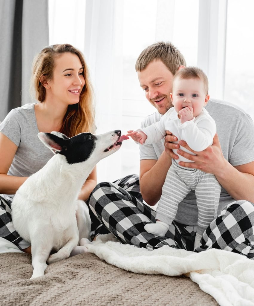 Family with dog in the bed