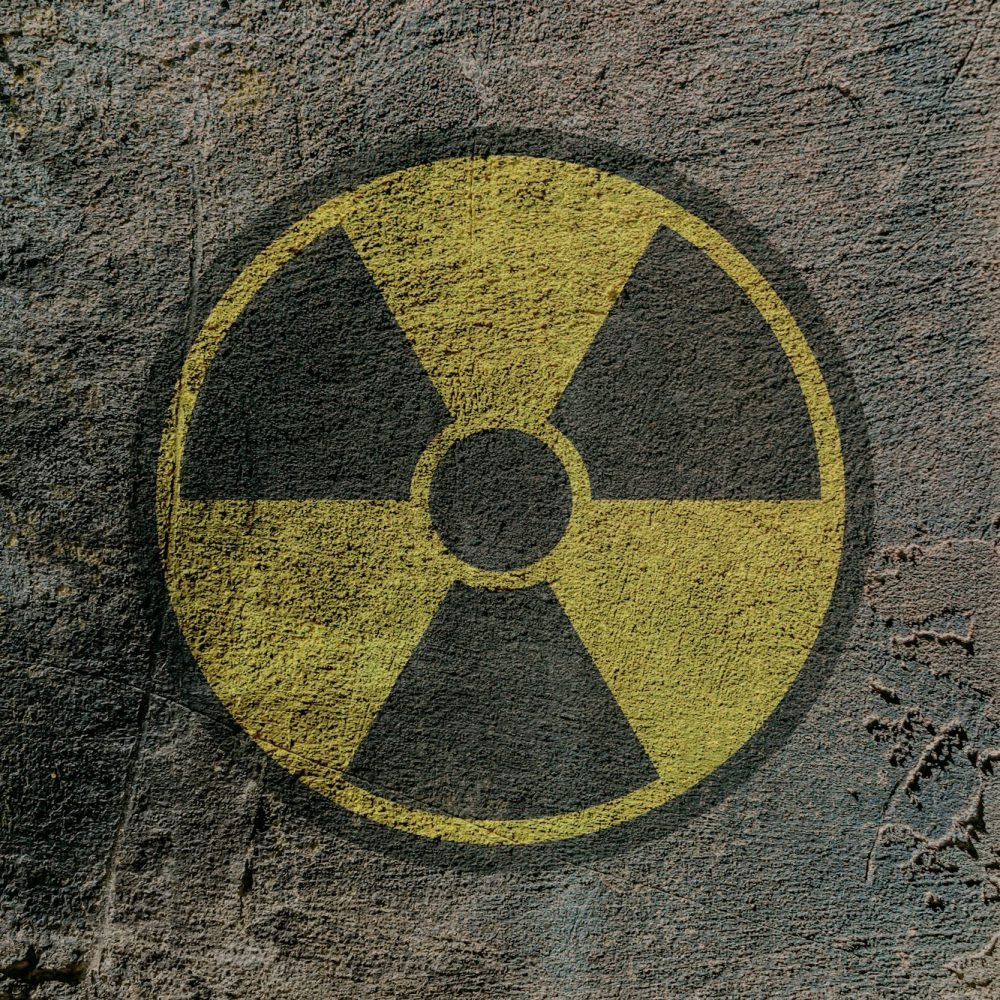 Sign of radioactive danger depicted on a concrete wall